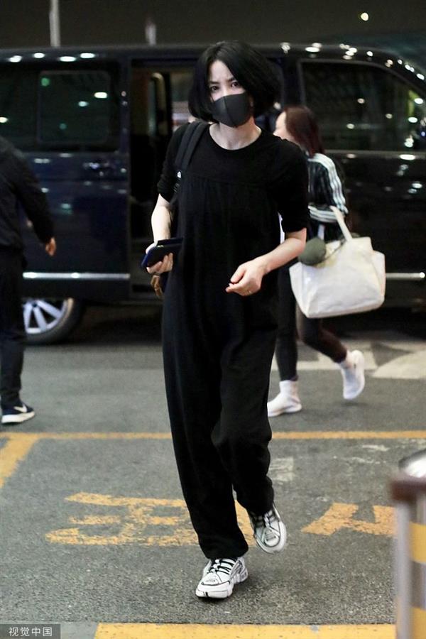 9月5日，王菲现身北京机场。她戴着口罩，身穿一身黑色休闲装低调随性，迈大步赶路潇洒十足，玩“摸头杀”十分宠溺。